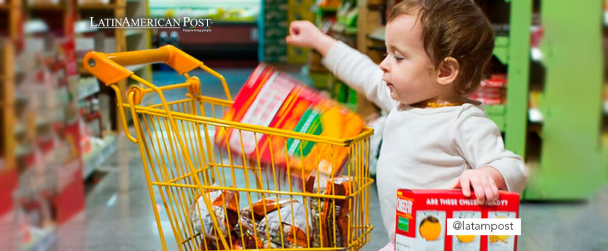 Little girl packing products in a supermarket cart