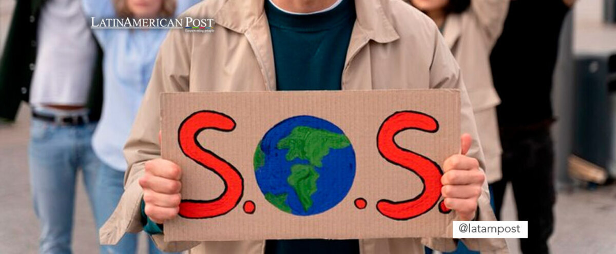 Man holding a sign that says 'SOS'