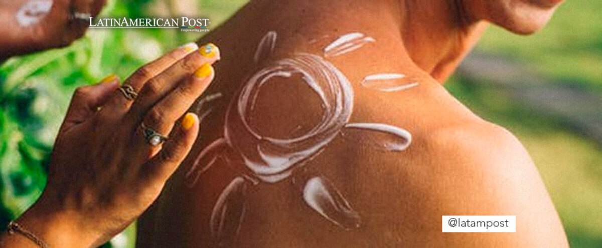 Woman applying sunscreen to a man on his back