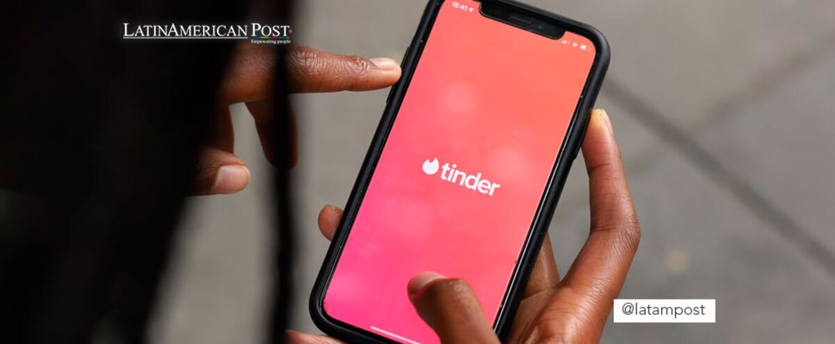 Woman holding cell phone with Tinder app