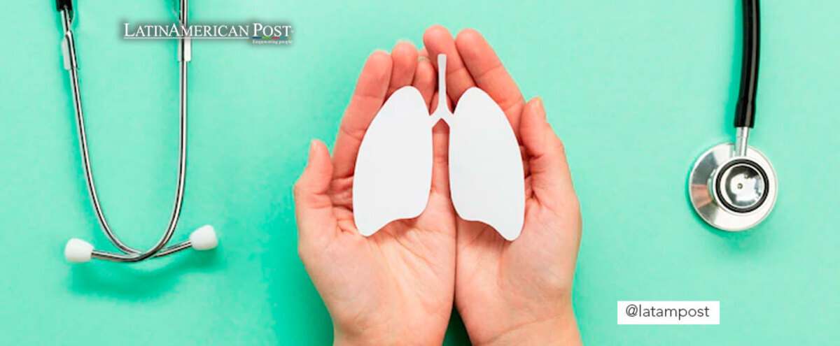 Hands holding a paper cut out figure of lungs