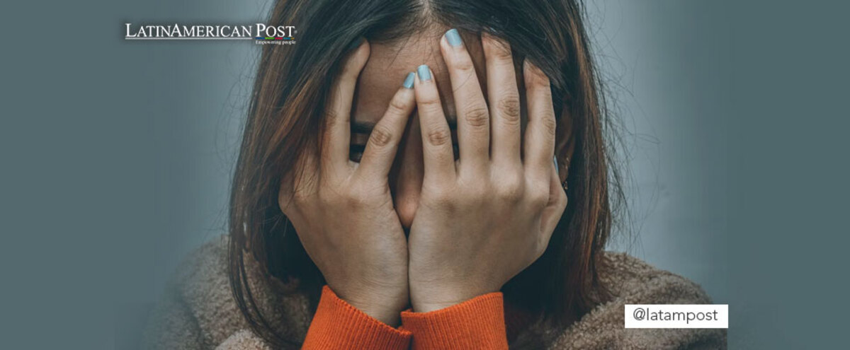 Woman covering her face with her hands