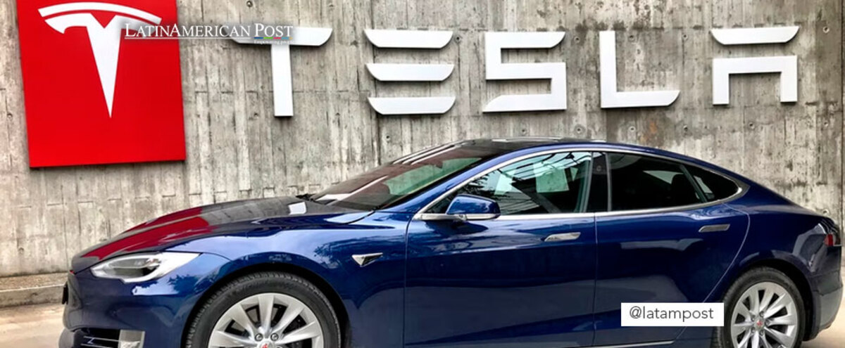 Tesla sign with a car model in front