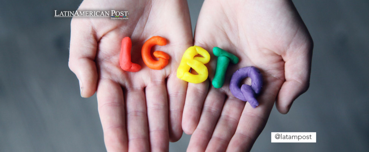 Hands holding the letters LGBTIQ