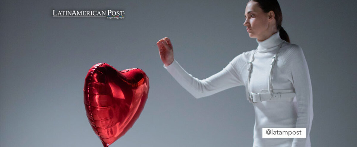 Woman blowing up a heart shaped balloon