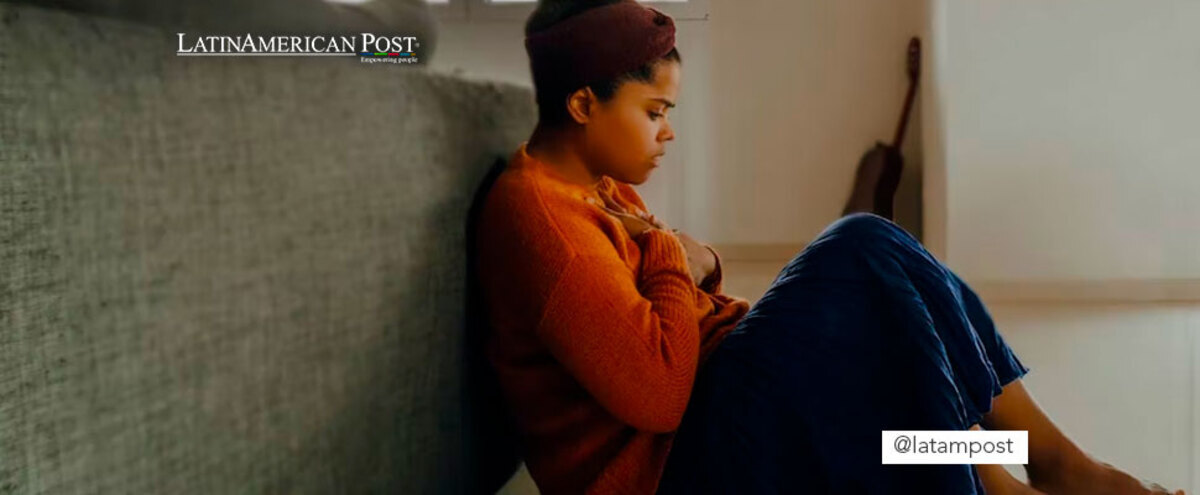 Woman sitting on the floor with a worried expression