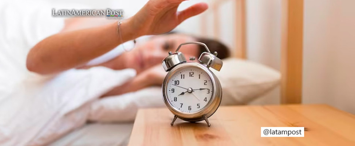 Woman turning off her alarm clock