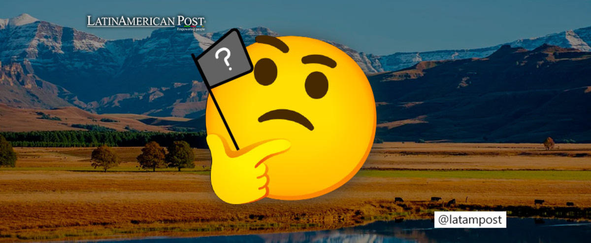 Emoji with a pensive face and behind a background of mountains with a lake