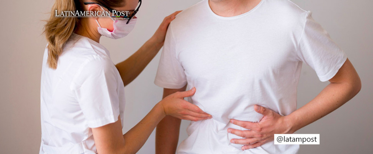 Woman examining man with pain in abdomen