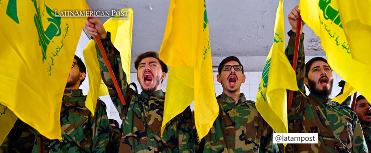 Hezbollah militants shout slogans during a funeral