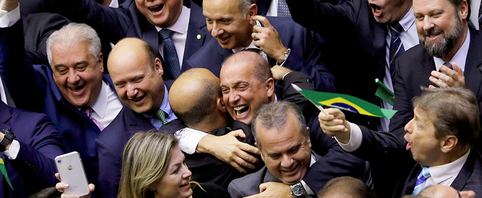 Members of Congress celebrate the vote of the pension reform bill