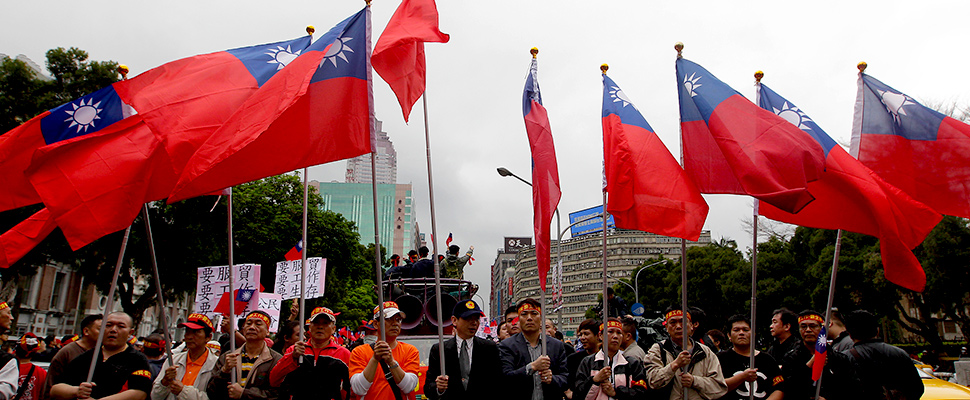 Activists holding Taiwan's national flags shout slogans during a rally near the Legislative Yuan, or Taiwan's parliament, in Taipei April 1, 2014.