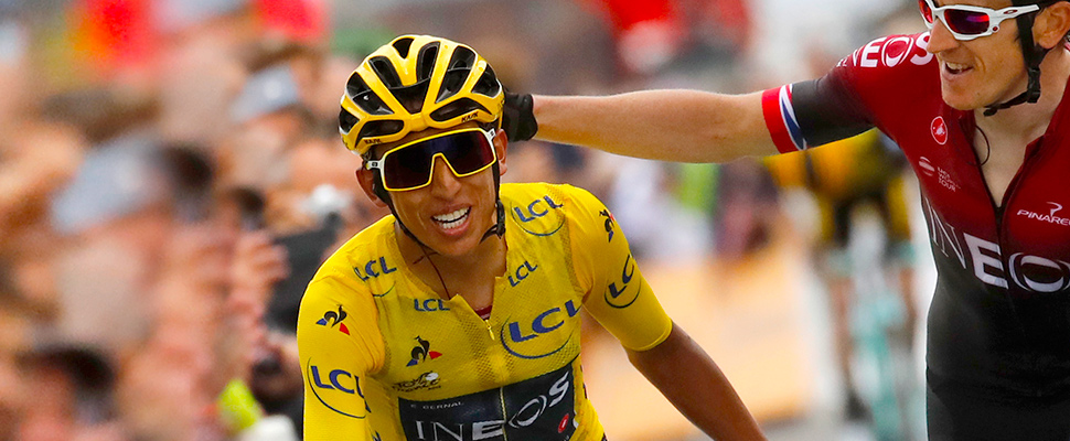 Britain's Geraint Thomas, right, congratulates Colombia's Egan Bernal wearing the overall leader's yellow jersey as they crosses the finish line of the twentieth stage of the Tour de France