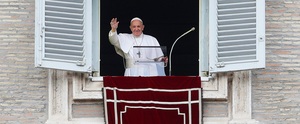 Pope Francis salutes from the window of his studio overlooking St. Peter's square at the Vatican, Sunday, July 28, 2019.