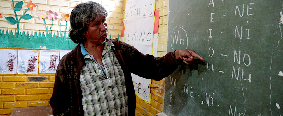 Teacher Blas Duarte shows letters in the Maka language at a school used by children of the Paraguayan ethnic group Maka, in Mariano Roque Alonso, Paraguay July 18, 2019.